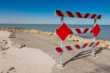 Barricade to a washed out road from coastal hurricane Harvey in Indianola, Texas.