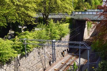 Railway tracks against the background of a stone wall and a bridge.