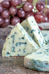 Fourme Ambert semi-hard French blue cheese made from raw cow milk served as dessert with grapes