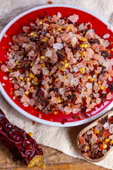 Gross sea salt mixed with dried red hot chili pepper, colorful seasoning close-up
