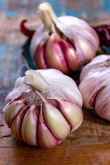 Three bulbs of fresh violet French garlic close up