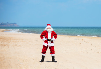 Christmas Santa Claus on the beach. New Year's travel vacation discounts and travel agencies price reductions concept.