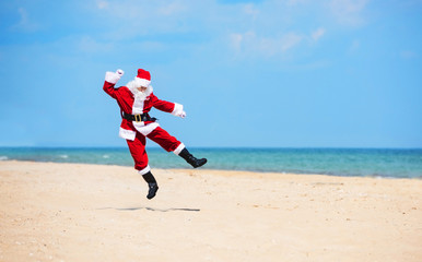 Christmas Santa Claus on the beach. New Year's travel vacation discounts and travel agencies price...
