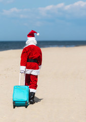 Christmas Santa Claus on the beach. New Year's travel vacation discounts and travel agencies price...