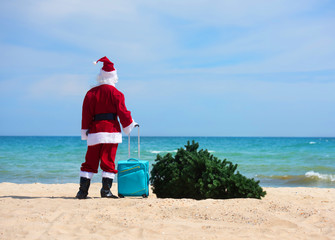 Christmas Santa Claus on the beach. New Year's travel vacation discounts and travel agencies price reductions concept.