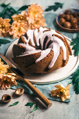 Brown cake with glaze and macadamia nut decorated with flowers