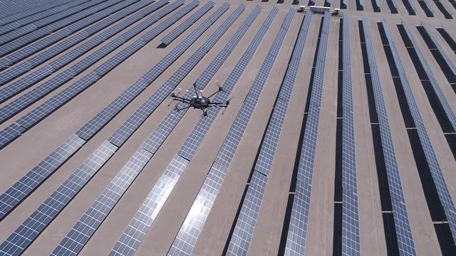 Drone survey, flying and working for thermal inspection analysis of Solar Energy PV Plants with visual and thermal camera. Aerial footage from drone to drone working inspecting the solar energy plant