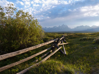 Fence and mountains  at sunset in Grand Teton National Park