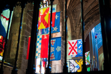 Edinburgh, Scotland - August 10, 2010: Flags of several Scottish and English clans hung inside a Scottish church in Edinburgh.