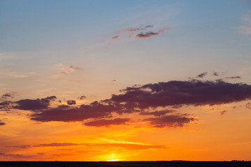 Landscape with bloody sunset. The terrain in southern Europe. Tragic gloomy sky. Purple-magenta clouds.