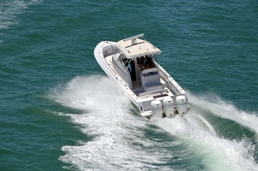 Young couple enjoying a high speed pleasure cruise on the Florida Intra-Coastal Waterway in a small...