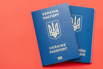 Ukrainian international biometric passport at red paper background. Documents for vacations.