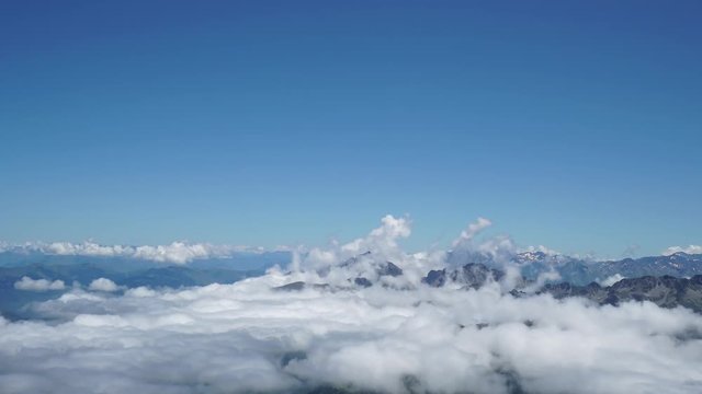 Mountains on Pic du Midi, France  with clouds moving on the surface. Bright light shot. 4K UHD Timelapse