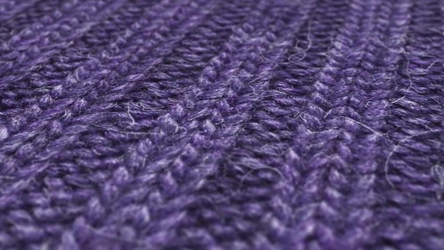 Purple wool, weaving pullover background. Close up, macro shot of vintage winter fabric cloth.