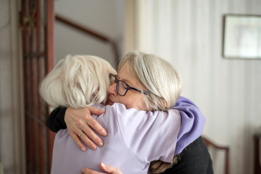 Emotional Goodbye,Mother And Daughter Embrace One Another.