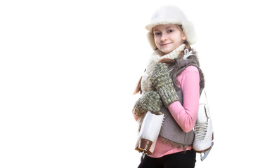 Portrait of Positive Smiling Caucasian Blond Girl in Winter Clothes. Posing Half-Turned with Ice Skates Over Shoulder In Hands In Front. Against White