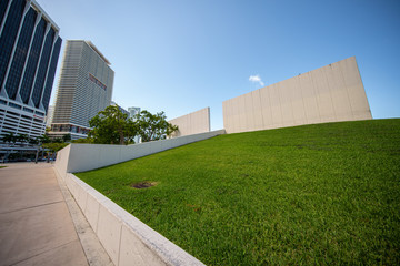 Mountain of grass in the city with high-rise buildings and background