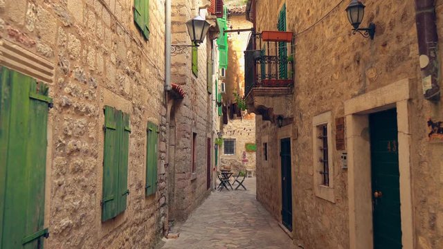 Narrow Passage In Montenegro. Daylight. Green Wooden Windows And Doors.