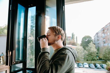 Fototapeta premium Young hipster drinks coffee at the office