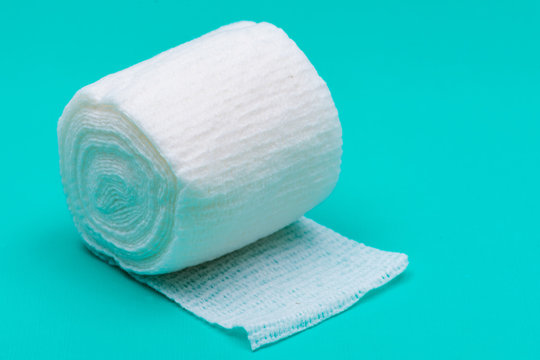 Hospital Grade Sterile Rolled Gauze On Green Background.