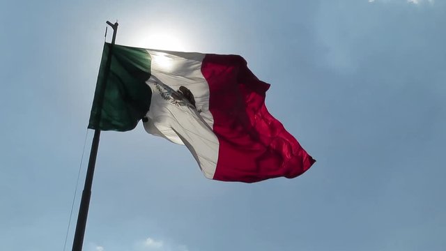 Mexico flag is dancing very softly on the wind in Mexico City