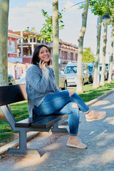 young girl talking on smartphone and typing messages with smartphone