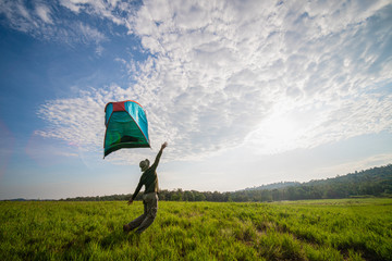 traveler having camping with tent on grass field and wind blow tent away