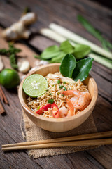 Close-up shot Instant noodles with lemon shrimp chilli hot and spicy on old wooden table select focus shallow depth of field