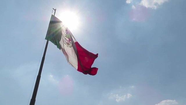 Mexico flag is dancing very softly on the wind in Mexico City