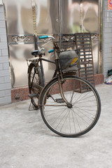 Fototapeta na wymiar Chinese people stopping classic retro vintage old bicycle with basket at front of house in old town at Chaozhou or Teochew in Guangdong, China
