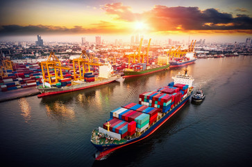 Fototapeta premium Logistics and transportation of Container Cargo ship and Cargo plane with working crane bridge in shipyard at sunrise, logistic import export and transport industry background