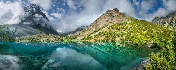 Tourism in Tajikistan, lake in the Fan Mountains. Scenic summer view, panorama landscape.  - obrazy, fototapety, plakaty