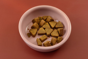 Chewy supplements for anxious fearful dogs and cats to help with anxiety and fear in pink bowl on red background