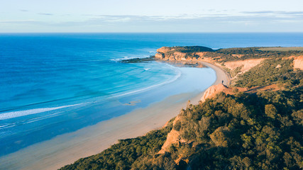 Aerial View of Beautiful Beach Coastline with Person on top of Cliffs Along the Great Ocean Road Australia