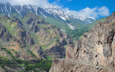 Fototapeta na wymiar Road over a deep gorge. Below is a tumultuous river Panj. Pamir Highway, Tajikistan.