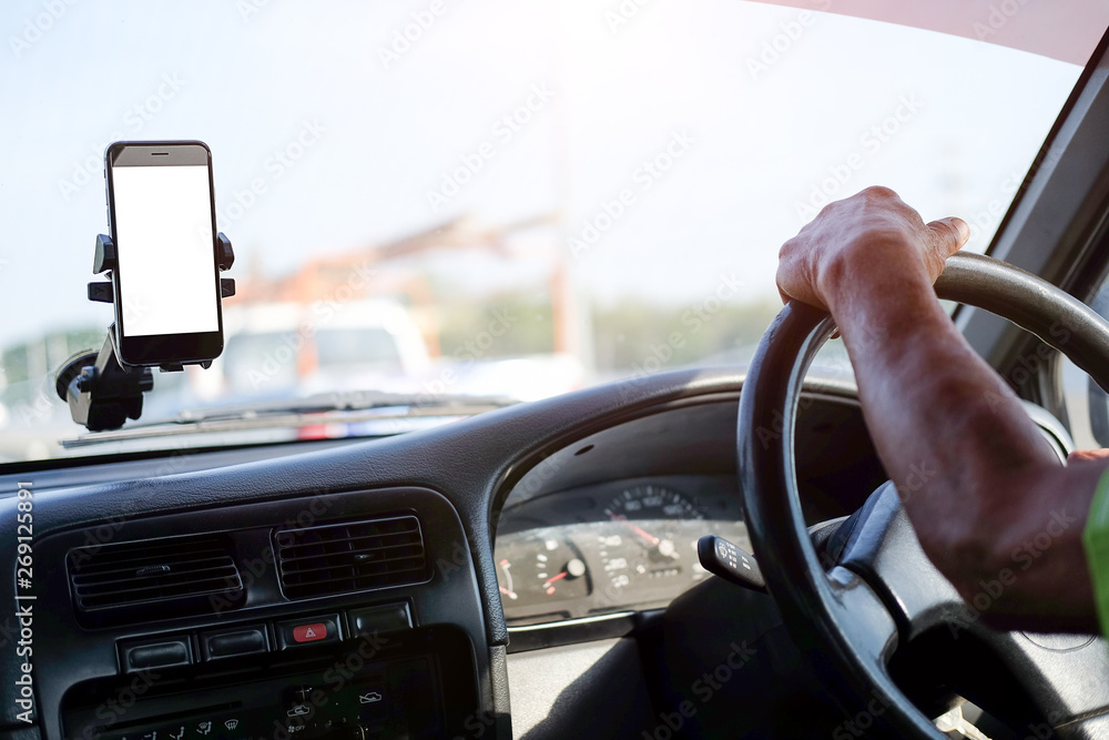 Poster cropped shot view the driver uses the phone while driving. modern smart phone with round edges. isol