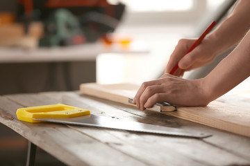 Obraz na płótnie Canvas Male carpenter working in shop