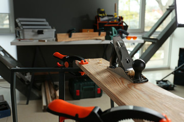 Planer with clamps in carpenter's workshop