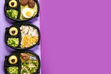 Containers with delicious food on color background