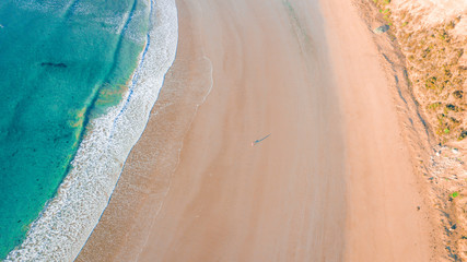 Fototapeta na wymiar Aerial View of Beautiful Beach Coastline with Person on top of Cliffs Along the Great Ocean Road Australia