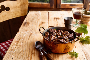 Serving of tasty venison deer goulash in a pot