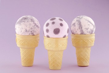bath bomb set. Purple  bath bombs with flower extract in waffle cones on a softly purple...