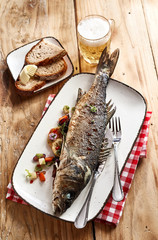 Whole oven grilled sea bass with a cold beer