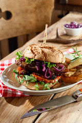 Speciality wild venison burger on a crusty bun - obrazy, fototapety, plakaty