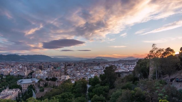 Malaga, Spain time lapse of sunset over aerial city view