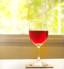 Fresh red grape juice and grapes on wooden garden table, refreshing organic antioxidant beverage 