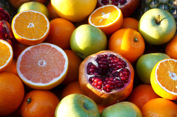 Heap of colorful orange, pomegranate and apple fruits as background
