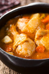 Fresh homemade chicken stew with potato, carrot and celery, seasoned with paprika in rustic bowl (Selective Focus, Focus one third into the stew)