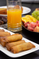 Iftar Buffet table. Spring roll, fresh orange juice, samosa snack, spring roll and fruit background concept iftar Ramadan