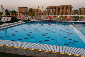 pool deck and parasols of luxury boat cruise ship in egypt luxor during dawn sunset